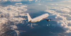 Plane flying. Blue sky and clouds
